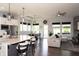Open-concept kitchen and living area with an island, stainless steel appliances, and abundant natural light at 13820 Woodside Hollow Dr, Carmel, IN 46032