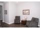 Living room with wood flooring, two comfortable chairs and neutral-colored walls at 13820 Woodside Hollow Dr, Carmel, IN 46032