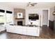 Modern living room with stone fireplace, a plush white sofa, and contemporary entertainment center at 13820 Woodside Hollow Dr, Carmel, IN 46032