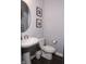 Classic powder room with a pedestal sink, toilet, and neutral wall color at 13820 Woodside Hollow Dr, Carmel, IN 46032