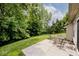 Enjoy outdoor dining on this home's patio, overlooking a lush green backyard surrounded by trees at 15308 Wolf Run Ct, Noblesville, IN 46060