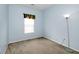 This bedroom with natural light boasts light blue walls and neutral carpeting at 15308 Wolf Run Ct, Noblesville, IN 46060