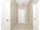 Entry hallway with tile flooring, featuring doors and neutral wall paint at 15308 Wolf Run Ct, Noblesville, IN 46060