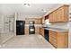 A well-lit kitchen featuring wood cabinets and modern black appliances at 15308 Wolf Run Ct, Noblesville, IN 46060