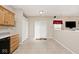 A kitchen area featuring wood cabinets, tile floors, and a sliding glass door at 15308 Wolf Run Ct, Noblesville, IN 46060