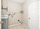 This laundry room offers tile flooring, white washer/dryer, and shelving at 15308 Wolf Run Ct, Noblesville, IN 46060
