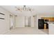 An open-concept living room with neutral colors and a modern ceiling fan at 15308 Wolf Run Ct, Noblesville, IN 46060