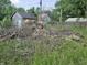 Backyard view of downed tree with sheds in the background at 1601 S Biltmore Ave, Muncie, IN 47302