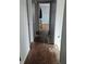 Hallway features multiple doorways with dark laminate flooring and gray walls at 1601 S Biltmore Ave, Muncie, IN 47302
