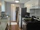 Kitchen with white cabinets, stainless steel appliances, and laminate flooring at 1601 S Biltmore Ave, Muncie, IN 47302
