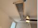 Attic access point in bedroom ceiling with ceiling fan at 1720 Rembrandt St, Indianapolis, IN 46202