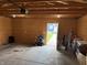 Well-lit garage with ample storage, featuring an overhead door and easy access to the outdoors at 1720 Rembrandt St, Indianapolis, IN 46202