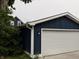 Exterior view of the detached garage featuring blue siding, white trim, and an overhead door at 1720 Rembrandt St, Indianapolis, IN 46202