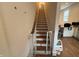 Staircase with wood treads and white risers, and white baby gate at 1720 Rembrandt St, Indianapolis, IN 46202