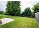 This home boasts a spacious grassy backyard surrounded by mature trees offering privacy and shade at 1792 Persimmon Grove Dr, Indianapolis, IN 46234