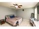 A cozy bedroom with a comfortable bed, neutral walls, carpet, and ceiling fan at 1792 Persimmon Grove Dr, Indianapolis, IN 46234