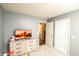A bright ' bedroom with light dresser and adjacent doorway at 1792 Persimmon Grove Dr, Indianapolis, IN 46234