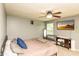 Spacious bedroom features a ceiling fan, television, and a bassinet near the bed at 1792 Persimmon Grove Dr, Indianapolis, IN 46234