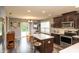 Modern kitchen featuring a center island with seating, stainless steel appliances, and dark cabinetry at 1792 Persimmon Grove Dr, Indianapolis, IN 46234