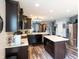 Open kitchen with island seating and stainless appliances at 1792 Persimmon Grove Dr, Indianapolis, IN 46234