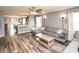 Open-concept living room featuring wood floors and view of the modern kitchen at 1792 Persimmon Grove Dr, Indianapolis, IN 46234