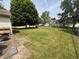 Spacious backyard with a green chain-link fence and mature trees at 19409 Mimosa Ct, Noblesville, IN 46060