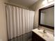 Bathroom featuring a shower with a white curtain, dark wood vanity, and framed mirror at 19409 Mimosa Ct, Noblesville, IN 46060