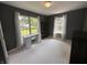 Inviting bedroom with nice light, carpet over concrete floors, and two large windows at 19409 Mimosa Ct, Noblesville, IN 46060