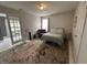 Relaxing bedroom with a bed, an area rug on concrete floors, and glass doors to another room at 19409 Mimosa Ct, Noblesville, IN 46060