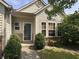 A close-up of a charming home's front entrance, complete with a well-manicured garden and lush green shrubbery at 19409 Mimosa Ct, Noblesville, IN 46060