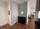 A cozy hallway featuring elegant decor, wood floors, and a glimpse into an adjacent living space with a fireplace at 19409 Mimosa Ct, Noblesville, IN 46060
