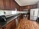 Well-equipped kitchen featuring dark wood cabinetry, stainless steel appliances, and a functional layout for cooking at 19409 Mimosa Ct, Noblesville, IN 46060