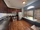 Spacious kitchen with dark wood cabinets, stainless steel appliances, and a sunlit nook featuring built-in seating at 19409 Mimosa Ct, Noblesville, IN 46060