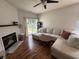 Bright living room features a fireplace, a ceiling fan, and a comfortable sectional sofa at 19409 Mimosa Ct, Noblesville, IN 46060
