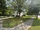 A verdant street view showcasing the property and its surroundings, enhanced by mature trees and lush greenery at 19409 Mimosa Ct, Noblesville, IN 46060