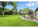 Lush backyard with ample space, patio with outdoor seating under gazebo, fire pit, and mature trees at 19433 Tradewinds Dr, Noblesville, IN 46062