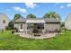 Beautiful backyard offers a patio with a gazebo, ample seating, fire pit, and lush green lawn at 19433 Tradewinds Dr, Noblesville, IN 46062