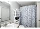 This bathroom features a blue patterned shower curtain and white storage cabinet at 19433 Tradewinds Dr, Noblesville, IN 46062