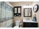 Well-lit bathroom features a vanity with storage, updated fixtures, and a shower with a stylish curtain at 19433 Tradewinds Dr, Noblesville, IN 46062
