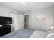 Bright bedroom featuring neutral walls, comfortable bed, and sleek black dresser for ample storage at 19433 Tradewinds Dr, Noblesville, IN 46062