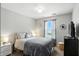 Cozy bedroom featuring soft gray hues, comfortable bedding, and natural light from the window at 19433 Tradewinds Dr, Noblesville, IN 46062