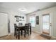 Cozy dining area features a dark wood table and chairs, a window, and door to the exterior at 19433 Tradewinds Dr, Noblesville, IN 46062