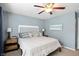 The main bedroom features a ceiling fan, side tables, and wall art above the bed at 19433 Tradewinds Dr, Noblesville, IN 46062