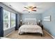 The main bedroom features a ceiling fan, lamps, and large window with beautiful curtains at 19433 Tradewinds Dr, Noblesville, IN 46062