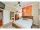Inviting bedroom with a wooden bed frame, neutral carpet, and an abstract orange and red painting at 2105 N Meridian St # 203, Indianapolis, IN 46202