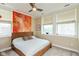 Bright bedroom with a wooden bed frame, plush carpet, and multiple windows offering natural light at 2105 N Meridian St # 203, Indianapolis, IN 46202