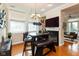 Cozy dining area features a round table with bench seating and a view of a fireplace and living room at 2105 N Meridian St # 203, Indianapolis, IN 46202