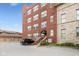 Brick apartment building with covered entryway, adjacent parking lot and professionally landscaped grounds at 2105 N Meridian St # 203, Indianapolis, IN 46202