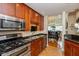 Kitchen with stainless appliances, wood cabinets, and bar stool seating at 2105 N Meridian St # 203, Indianapolis, IN 46202