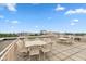 Spacious rooftop deck with patio furniture offers panoramic city views and ample seating for entertaining at 2105 N Meridian St # 203, Indianapolis, IN 46202